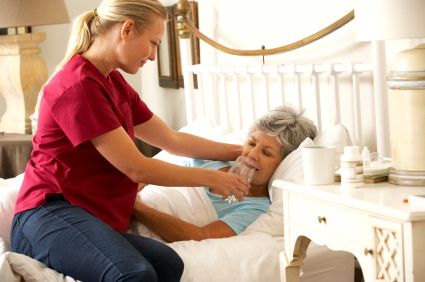 Caregiver taking care of a dehydrated senior woman